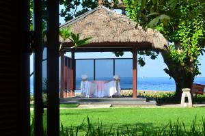 a wedding reception in a gazebo on the beach at Pool Villa Merumatta Senggigi in Senggigi
