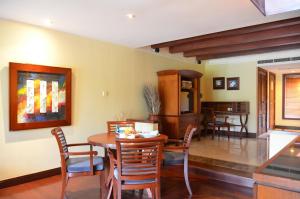 a dining room with a table and chairs at Pool Villa Merumatta Senggigi in Senggigi