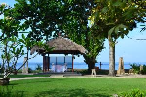 a wedding reception in a gazebo on the beach at Pool Villa Merumatta Senggigi in Senggigi