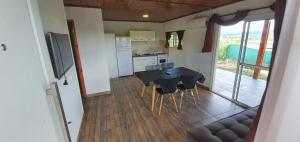 a kitchen and dining room with a table and chairs at Terrazas de Estancia in Villa Carlos Paz