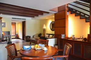 a kitchen and living room with a table and chairs at Pool Villa Merumatta Senggigi in Senggigi