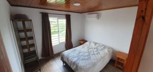 a bedroom with a bed and a window at Terrazas de Estancia in Villa Carlos Paz