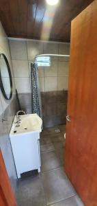 a bathroom with a sink and a mirror at Terrazas de Estancia in Villa Carlos Paz +35 photos