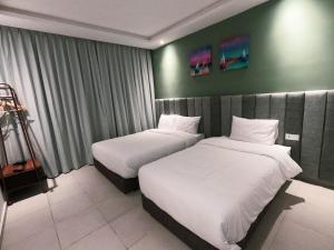 a hotel room with two beds in it at Hotel Dakhla Ville in Dakhla +28 photos