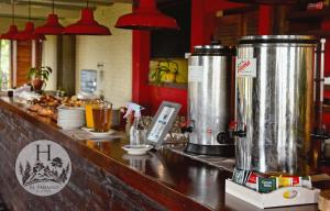 a counter in a restaurant with two large tanks at Hotel El Paraiso De La Sierra in Tandil