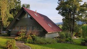 a small house with a red roof at Ferienhaus Chiemgauer Auszeit- Chiemgaukarte inclusive in Siegsdorf