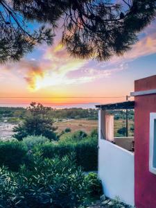 a sunset over the ocean from a house at Pernakria in Skala Rachoniou