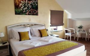 a bedroom with a large bed with yellow and white pillows at B&B Secret Garden in Voeren