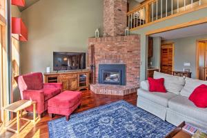a living room with a couch and a fireplace at Wooded Waterfront Grantham Home Less Than 10 Mi to Ski! in Grantham