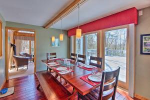a dining room with a wooden table and chairs at Wooded Waterfront Grantham Home Less Than 10 Mi to Ski! in Grantham