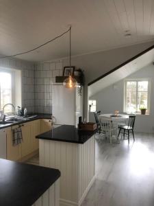a kitchen and dining room with a table with chairs at Östernäs in Grebbestad