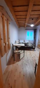 a room with a bed and a table and chairs at Пасторальний дім імені Владики Мілана in Bohdan
