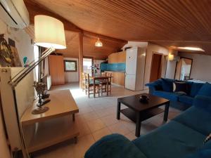 a living room with a blue couch and a table at Hotel Flesvos in Pefkochori
