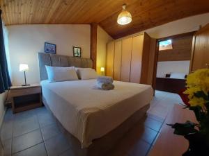 a bedroom with a bed with a stuffed animal on it at Hotel Flesvos in Pefkochori +58 photos