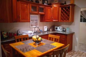 a kitchen with a table with a fruit bowl on it at Ocho Rios Hideaway in Ocho Rios