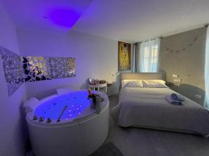 Blue House Varenna في فارنا: غرفة نوم مع حوض كبير بجوار سرير