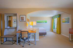Habitación de hotel con cama, escritorio y cama en Holiday Inn & Suites Spring - The Woodlands, en Spring
