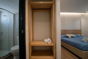a small bedroom with a bed and a toilet at Villa Margarita Suites in Hersonissos