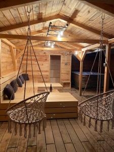 a sauna with two chairs and a swing in a room at UBYTOVÁNÍ S WELLNESS in Dolní Dobrouč