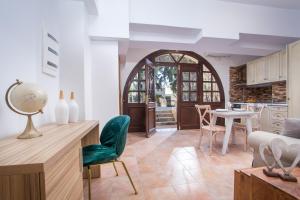a kitchen and living room with a table and chairs at Kamara Antica Apartments in Rhodes Town +33 photos