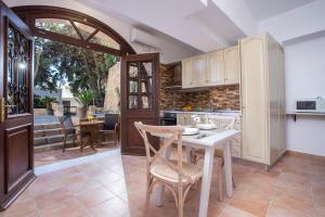 a kitchen with a table and chairs and a dining room at Kamara Antica Apartments in Rhodes Town