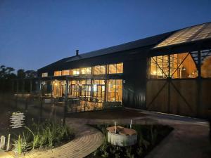 a building with a lot of windows at night at Insaka's 2 Greenlee Apartment - Greenlee Lifestyle Centre, Sandton in Sandown