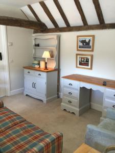 a bedroom with a desk and a bed at The Byre at Heartwood in Ticehurst