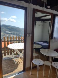 a room with a view of a balcony with tables and chairs at Bungalow Sixdays 3 in Camporosso