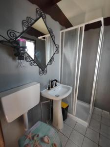 a bathroom with a sink and a mirror at Bungalow Sixdays 3 in Camporosso +49 photos
