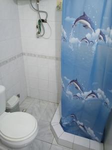 ein Badezimmer mit einem Duschvorhang mit Delfinen im Himmel in der Unterkunft 4 aguas in Santa Ana