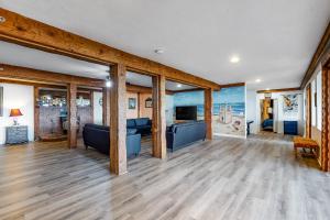 a living room with wooden floors and a living room with blue furniture at Inn at Sandcastle Beach in Waldport