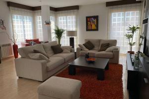 a living room with two couches and a coffee table at Apartamento Miramar . Amplitud y Comodidad in Almazora
