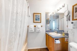 a bathroom with a sink and a shower at Inn at Sandcastle Beach in Waldport +33 photos