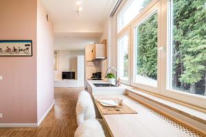 a living room with a couch and a large window at La Vista in Tervuren