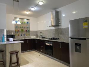 a kitchen with a stainless steel refrigerator and a counter at Apartaestudio amplio in Barranquilla