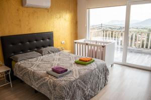 a bedroom with a bed and a large window at MountainBeach in San Vicente del Raspeig +63 photos