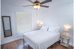 a white bedroom with a bed and a ceiling fan at Tobin Hill 3-2 Apt 5minDT 2min Pearl and St Marys in San Antonio
