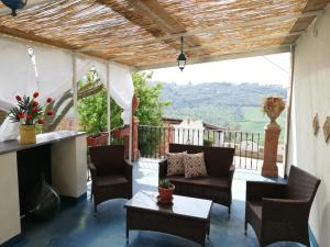 a patio with chairs and a table with a view at Casale Di Benedetto in Caltagirone +26 photos