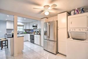 a kitchen with white appliances and a ceiling fan at Quaint Jungle Hideaway Near Downtown St Pete in St. Petersburg
