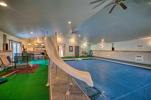 a indoor swimming pool with a slide in a house at Unique Cabin with Indoor Pool and Mountain Views! in Livingston