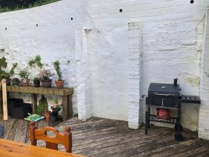a outdoor patio with a grill and a table at Mariyka House in Torquay