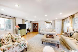 a living room with two couches and a tv at Pine Street Haven in Edgartown