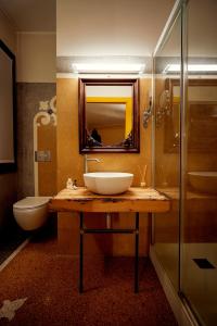 ein Badezimmer mit einem Waschbecken, einem WC und einem Spiegel in der Unterkunft Cinqueteste Luxury Home in Venedig