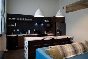 a kitchen with a blue couch and a counter top at 3E - *Renovated* 3 min to Hillman Cancer Center Sleeps 6 in Pittsburgh