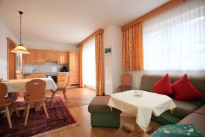 a living room with a couch and a table at Appartement Lisa Schweiger in Kirchberg in Tirol