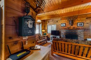a living room with a tv and a fireplace in a cabin at Williams Cabin in Shaver Lake