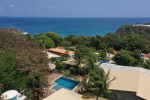 an aerial view of a resort with a swimming pool and the ocean at Pousada Recanto in Fernando de Noronha