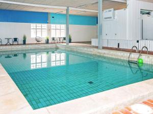 a large swimming pool in a building at 6 person holiday home in H jer in Højer