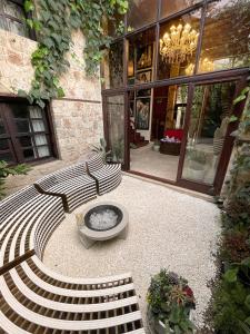 a patio with a bench and a fire pit in front of a building at Hotel Mille Kaleiçi in Antalya