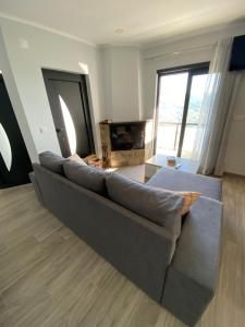 a large couch in a living room with a fireplace at Casa da Sacota - Douro View in Baião